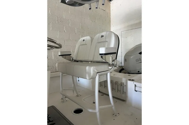 Slide: The Image of 2024 Sea Pro 230 Bay boat seating with white cushioned seats and armrests. - 4