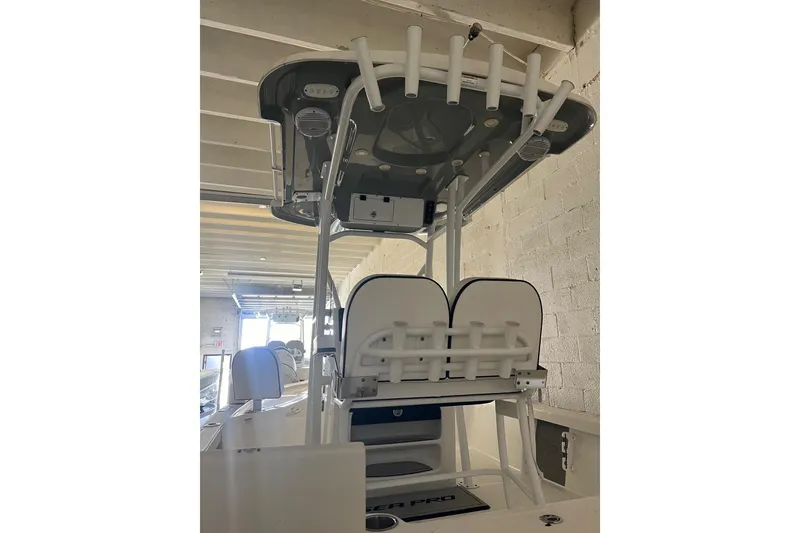 Slide: The Image of 2024 Sea Pro 230 Bay boat interior with seating and rod holders. - 5