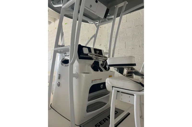 Slide: The Image of 2024 Sea Pro 230 Bay boat interior with steering console and seating. - 6