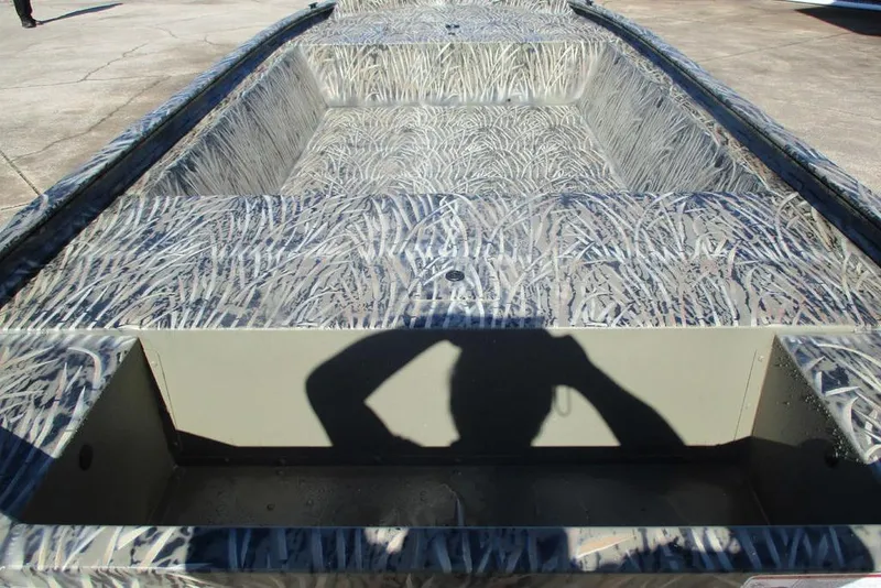 Slide: The Image of 2026 Tracker Grizzly 1648 Utility boat with camouflage interior design. - 2