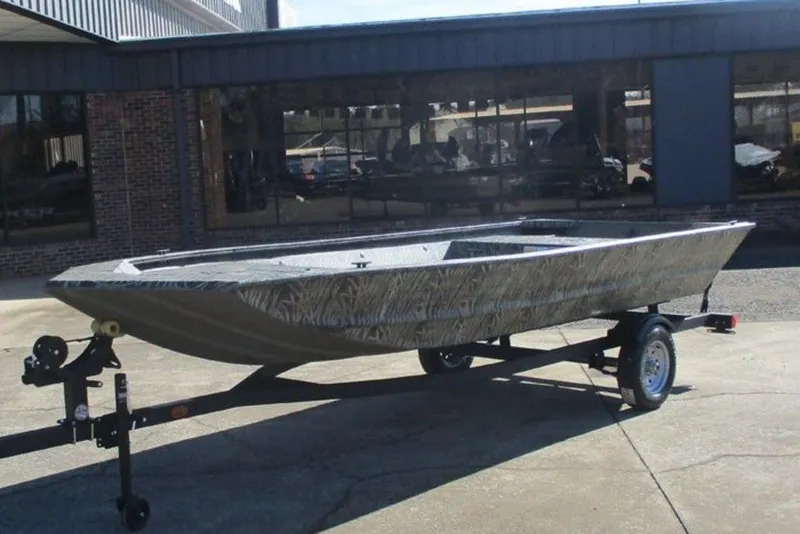 Slide: The Image of 2026 Tracker Grizzly 1648 Utility boat on trailer outside a building. - 4