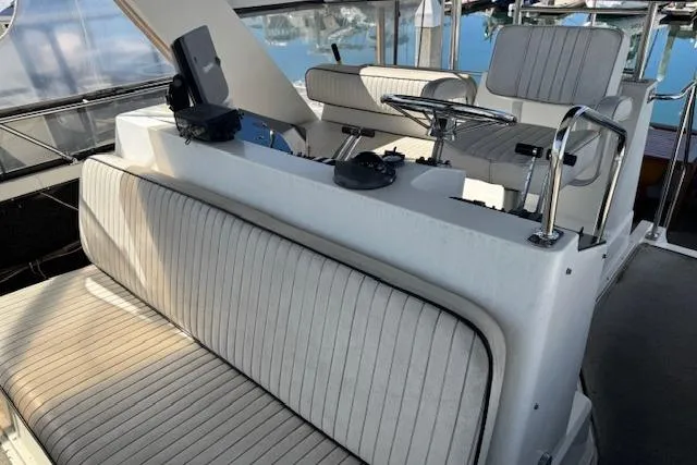 Slide: The Image of 1986 Carver 4207 Aft Cabin Motor Yacht helm with seating and controls. - 8