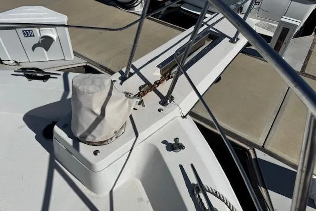 Slide: The Image of 1986 Carver 4207 Aft Cabin Motor Yacht deck with railing and dock view. - 11