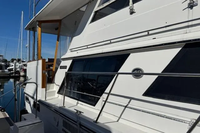 Slide: The Image of 1986 Carver 4207 Aft Cabin Motor Yacht docked at marina, side view. - 3