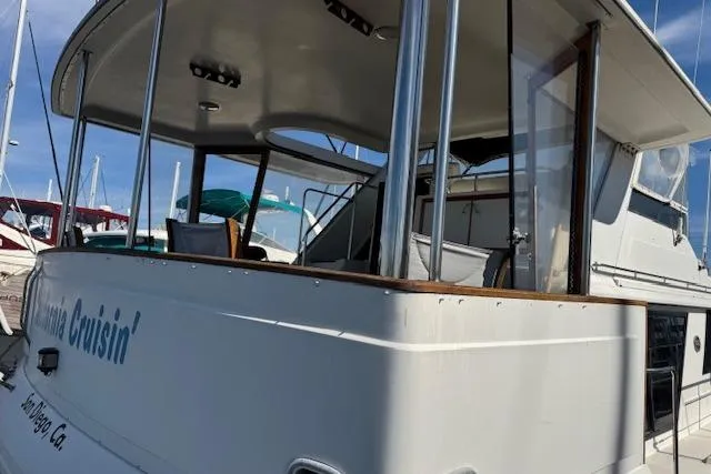 Slide: The Image of 1986 Carver 4207 Aft Cabin Motor Yacht docked, featuring spacious aft deck and sleek design. - 5