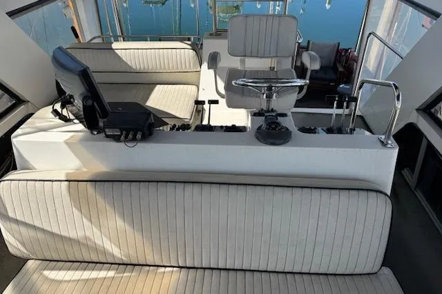 Slide: The Image of 1986 Carver 4207 Aft Cabin Motor Yacht helm with seating and control panel. - 7