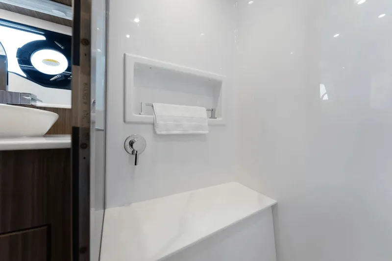 Slide: The Image of Women enjoying drinks on a 2026 Cruisers Yachts 50 GLS, with scenic water views. - 17