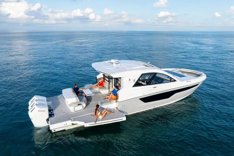 Slide: The Image of 2026 Cruisers Yachts 50 GLS luxury boat cruising on open water. - 4