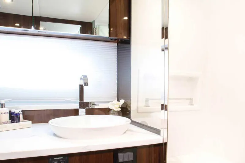 Slide: The Image of 2026 Cruisers Yachts 50 GLS with people enjoying the deck at sunset. - 12