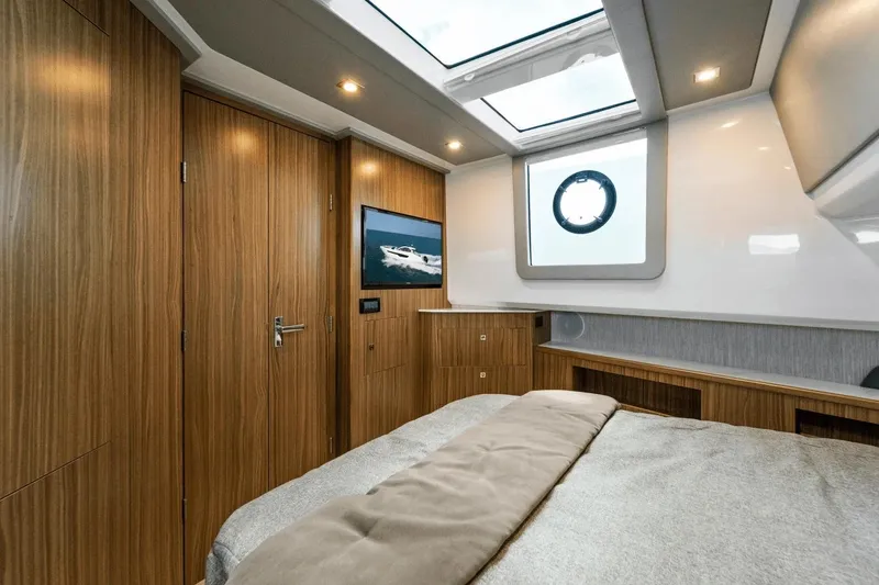 Slide: The Image of Luxurious bedroom interior of 2026 Cruisers Yachts 50 GLS with modern design and skylight. - 27