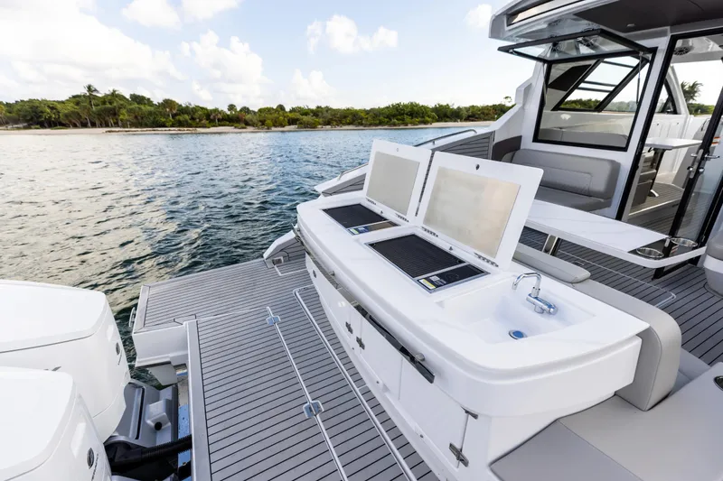 Slide: The Image of Aerial view of 2026 Cruisers Yachts 50 GLS on clear turquoise water. - 49