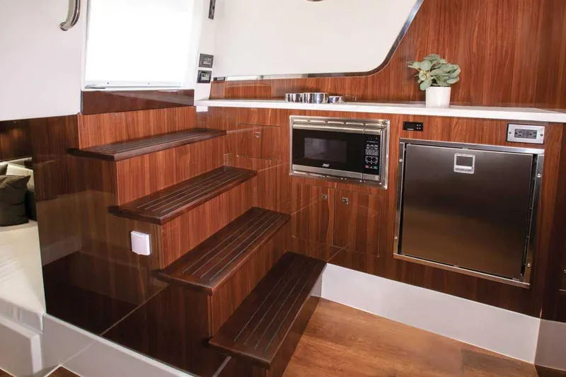 Slide: The Image of 2026 Cruisers Yachts 50 GLS on water with people enjoying the view. - 8