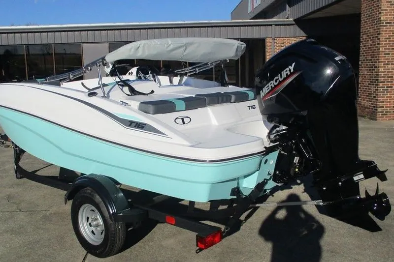 Slide: The Image of 2026 Tahoe T16 boat with Mercury engine on trailer, parked outdoors. - 2