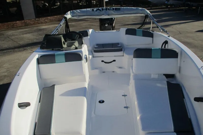 Slide: The Image of 2026 Tahoe T16 boat interior with white and gray seating, outdoor setting. - 6