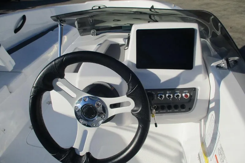 Slide: The Image of Steering wheel and dashboard of 2026 Tahoe T16 boat, featuring modern controls and display. - 7