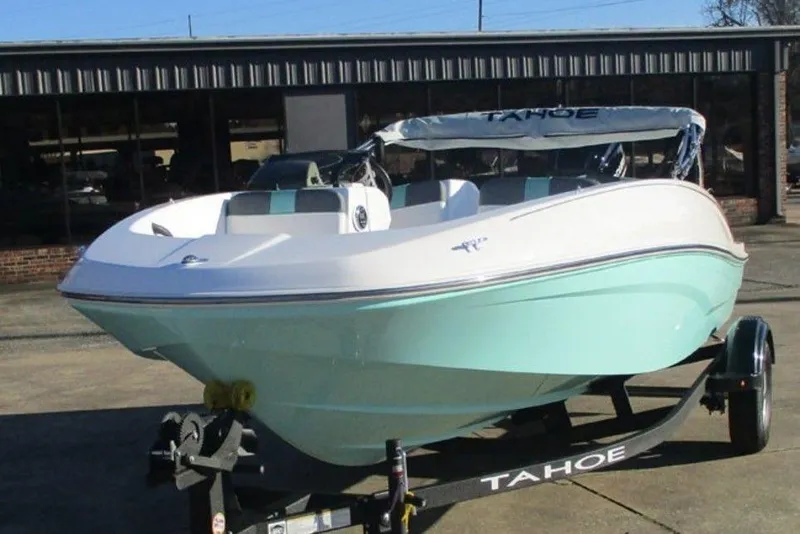 Slide: The Image of 2026 Tahoe T16 boat on trailer, white and mint green design, parked outdoors. - 8