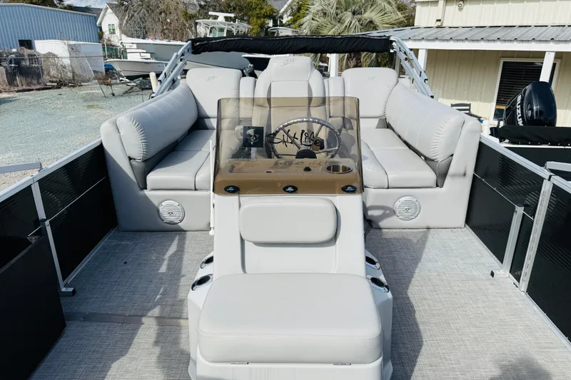 Slide: The Image of 2018 Silver Wave 230 Island CC boat interior with plush seating and steering console. - 10
