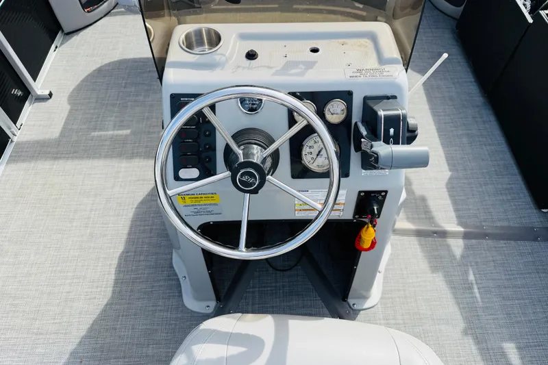 Slide: The Image of 2018 Silver Wave 230 Island CC boat console with steering wheel and controls. - 11