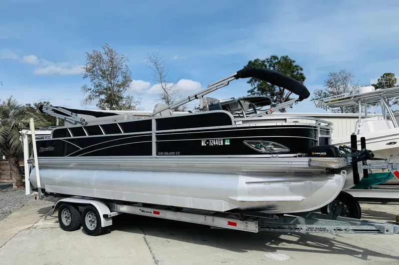 Slide: The Image of 2018 Silver Wave 230 Island CC pontoon boat on trailer, parked outdoors. - 5