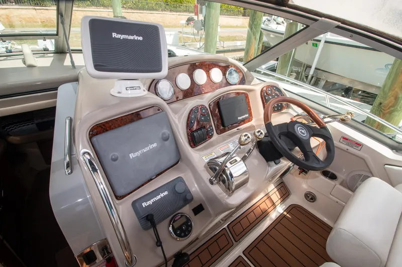 Slide: The Image of Helm of 2006 Sea Ray Sundancer 320 with Raymarine navigation system and wood accents. - 11