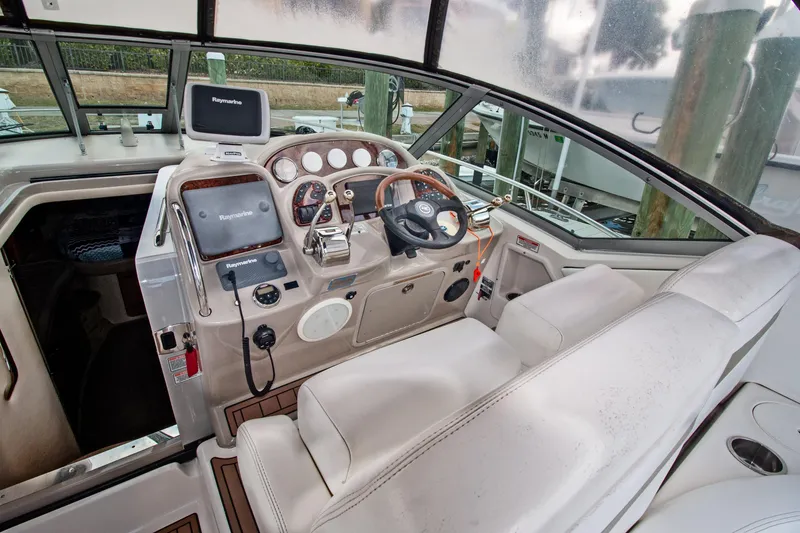 Slide: The Image of 2006 Sea Ray Sundancer 320 helm with Raymarine electronics and leather seating. - 17
