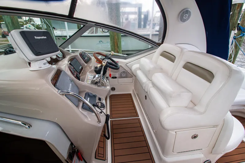 Slide: The Image of 2006 Sea Ray Sundancer 320 helm with white seating and modern navigation equipment. - 18