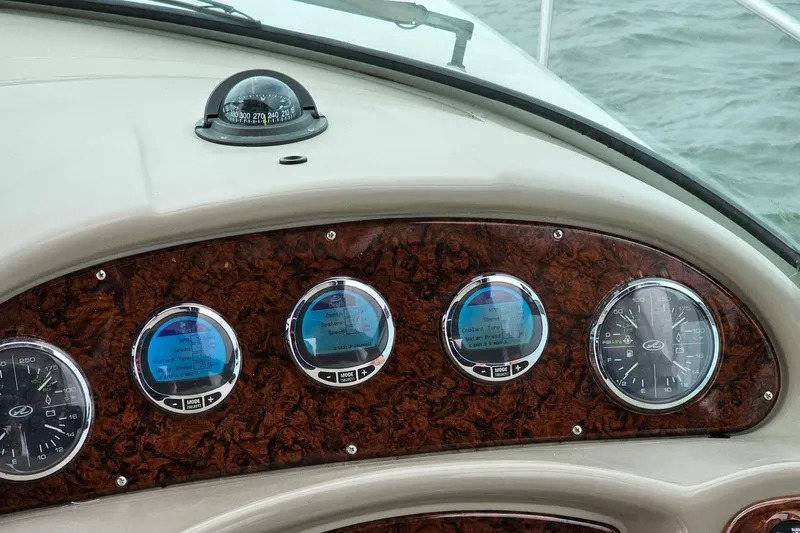 Slide: The Image of Dashboard of 2006 Sea Ray Sundancer 320 with gauges and compass on water. - 19