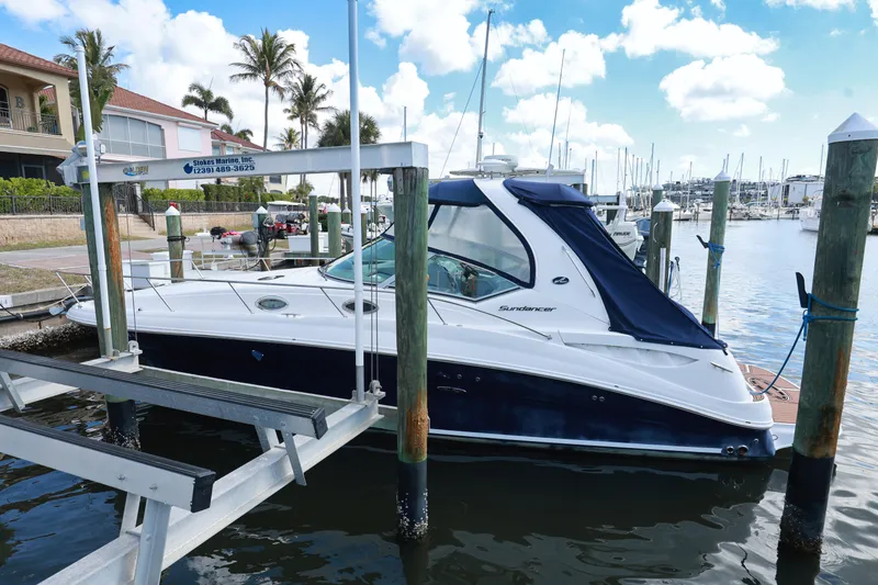 Slide: The Image of 2006 Sea Ray Sundancer 320 docked at marina with blue canopy. - 2