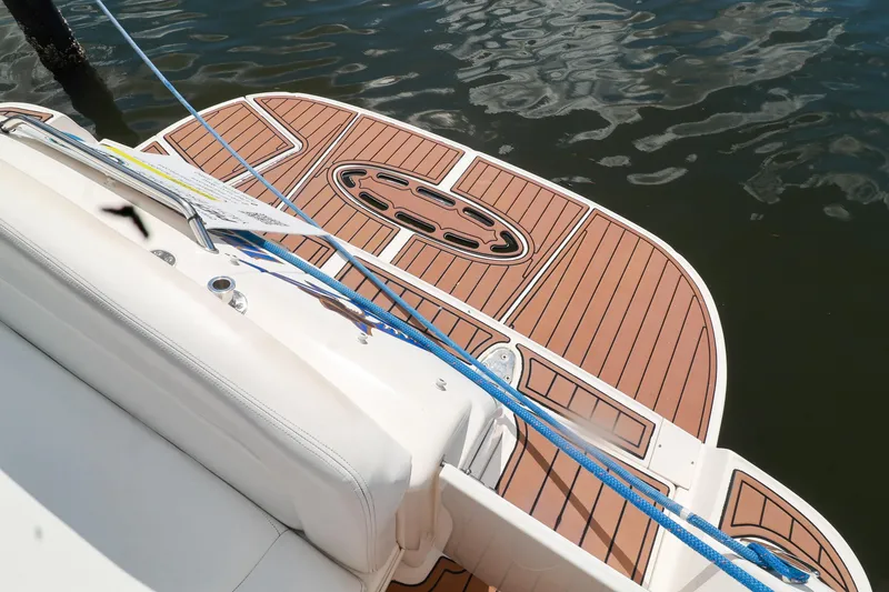 Slide: The Image of 2006 Sea Ray Sundancer 320 swim platform with teak decking and blue ropes. - 25
