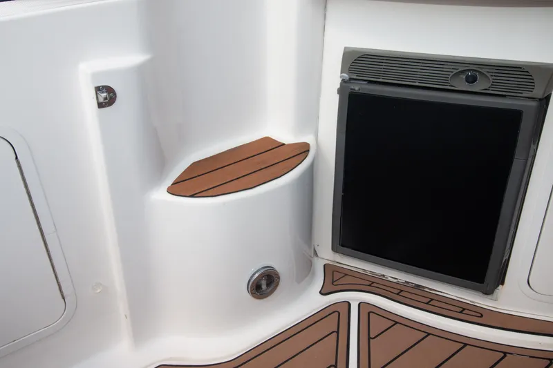 Slide: The Image of 2006 Sea Ray Sundancer 320 interior with wood accents and built-in refrigerator. - 26