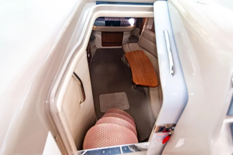 Slide: The Image of Interior cabin of 2006 Sea Ray Sundancer 320, featuring seating and wooden table. - 28