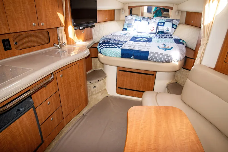 Slide: The Image of Interior of 2006 Sea Ray Sundancer 320 with cozy bed, kitchenette, and seating area. - 31