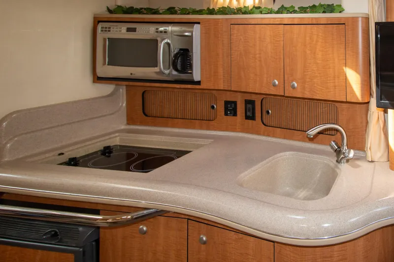 Slide: The Image of 2006 Sea Ray Sundancer 320 galley with microwave, stove, and sink. - 41