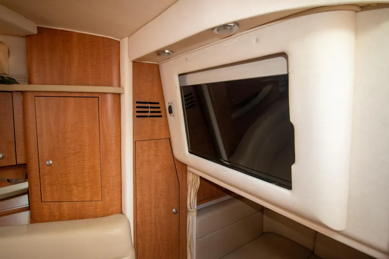 Slide: The Image of Interior of 2006 Sea Ray Sundancer 320 with wood cabinetry and mounted TV. - 47