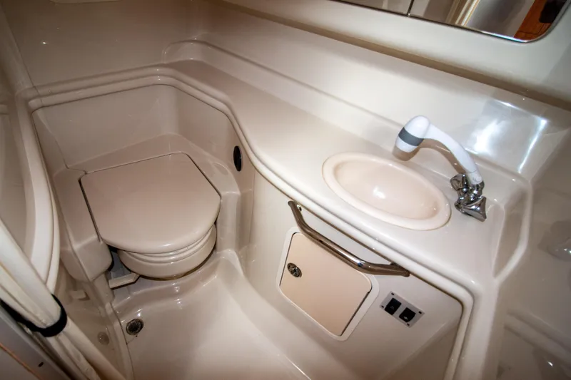 Slide: The Image of 2006 Sea Ray Sundancer 320 bathroom with compact toilet and sink. - 49