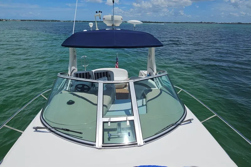 Slide: The Image of 2006 Sea Ray Sundancer 320 yacht on calm ocean waters under a clear blue sky. - 5