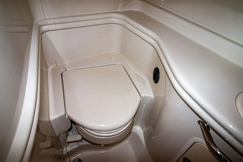 Slide: The Image of 2006 Sea Ray Sundancer 320 boat bathroom with compact toilet design. - 50