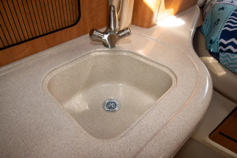Slide: The Image of 2006 Sea Ray Sundancer 320 interior sink with beige countertop and modern faucet. - 51