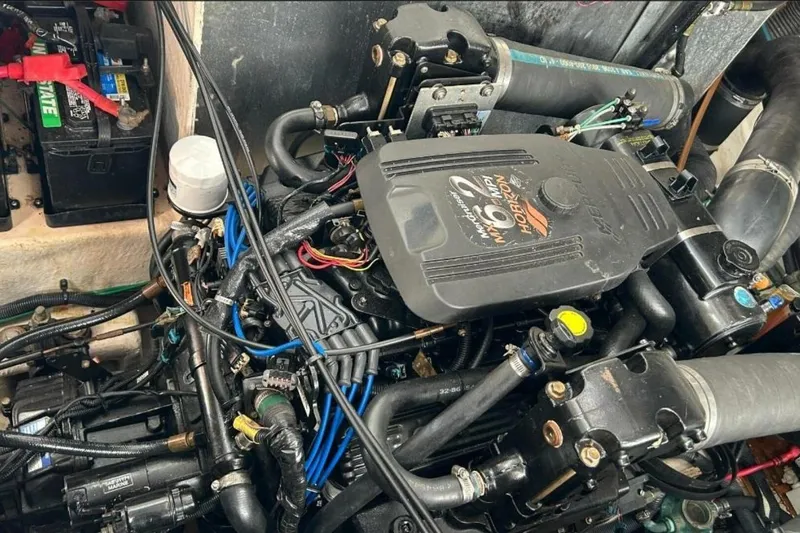Slide: The Image of Engine compartment of a 2006 Sea Ray Sundancer 320 boat, featuring a MerCruiser motor. - 56