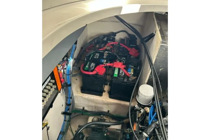 Slide: The Image of Battery compartment of a 2006 Sea Ray Sundancer 320 boat, showing wiring and connections. - 58
