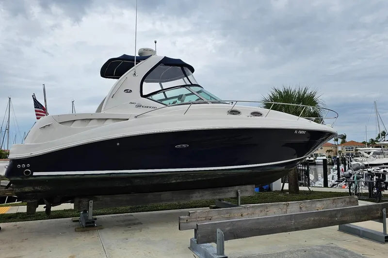 Slide: The Image of 2006 Sea Ray Sundancer 320 yacht on display at marina with American flag. - 7
