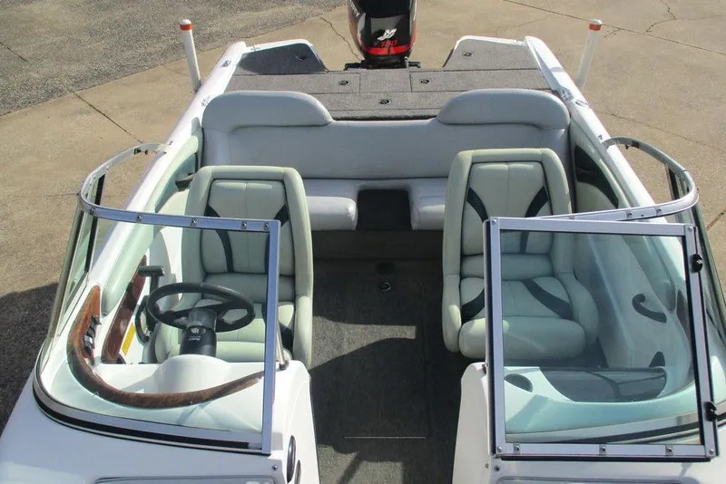 Slide: The Image of 2000 Triton SF-19 boat interior with dual seats and steering wheel, showcasing sleek design. - 6