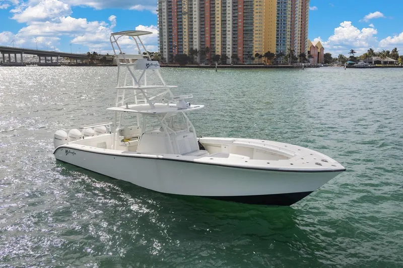 Slide: The Image of 2015 Yellowfin 39 Offshore boat on water with cityscape background. - 1