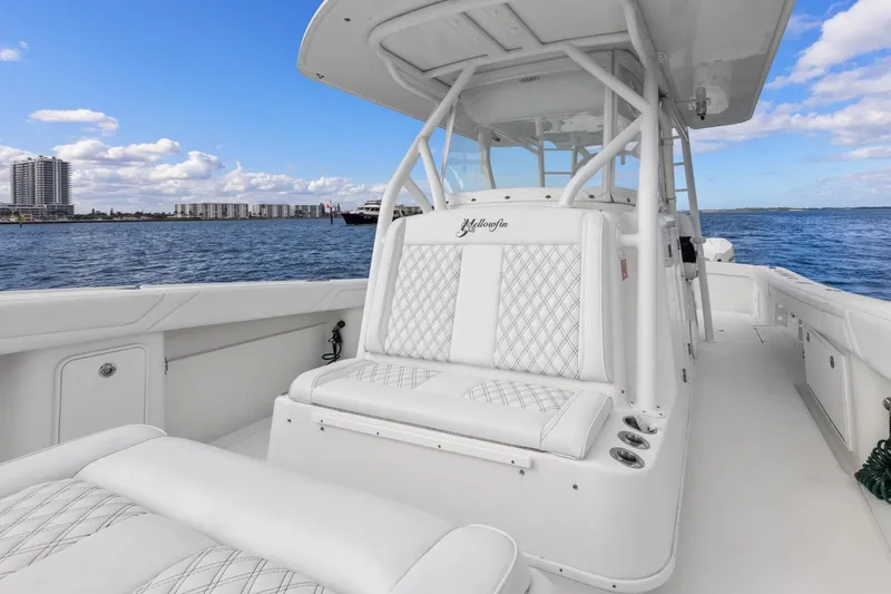 Slide: The Image of 2015 Yellowfin 39 Offshore boat with white seating, on calm water under blue sky. - 13