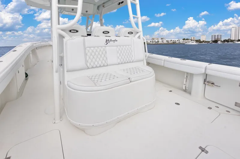 Slide: The Image of 2015 Yellowfin 39 Offshore boat interior with white seating, ocean view, and blue sky. - 20