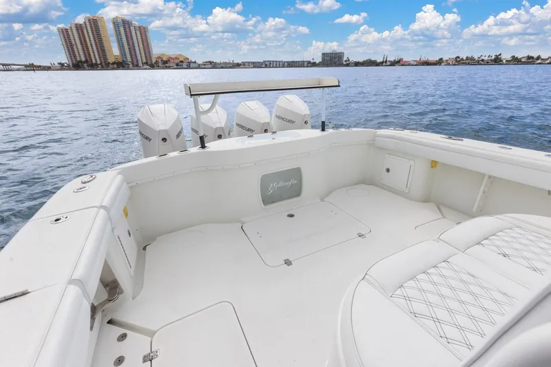 Slide: The Image of 2015 Yellowfin 39 Offshore boat with Mercury engines on calm water, cityscape background. - 23