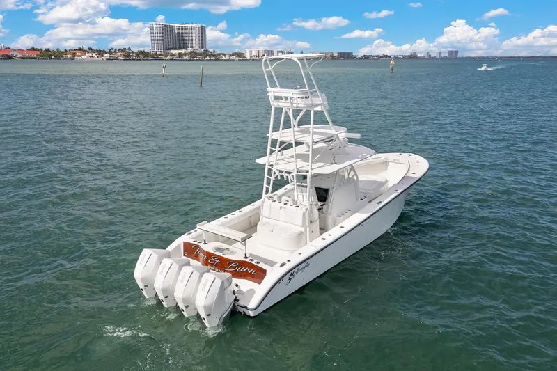 Slide: The Image of 2015 Yellowfin 39 Offshore boat on open water, clear sky, coastal background. - 4