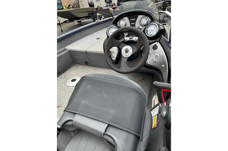 Slide: The Image of 2021 Bass Tracker Pro 17 boat interior with steering wheel and dashboard controls. - 4