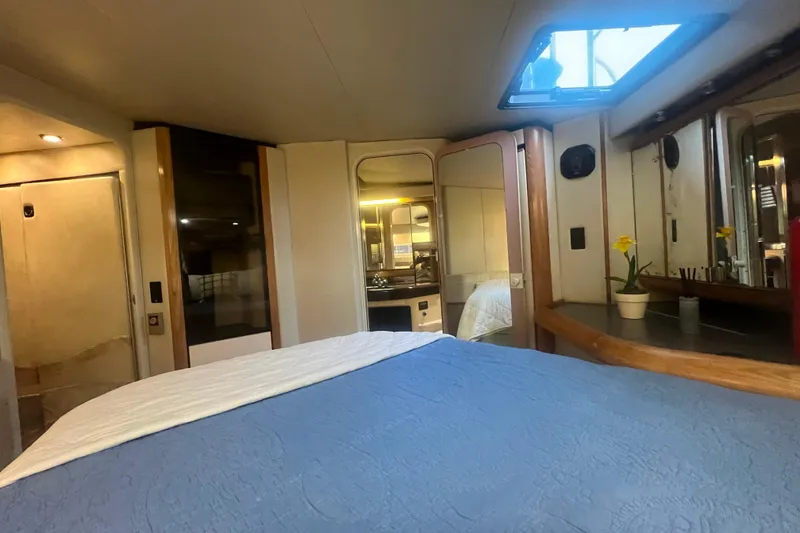 Slide: The Image of 1989 Bayliner 4285 Avanti interior with blue canopy and white seating. - 11