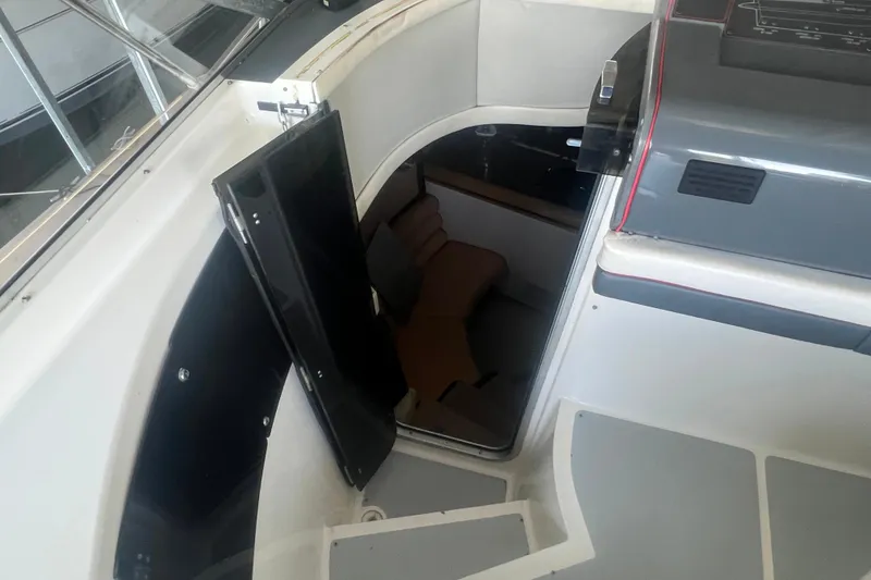 Slide: The Image of 1989 Bayliner 4285 Avanti interior with curved seating, kitchenette, and modern design elements. - 15